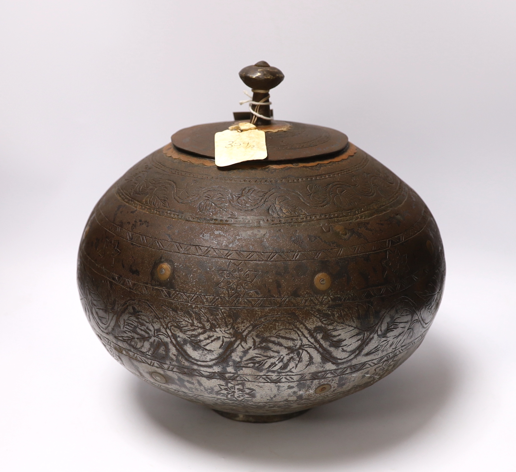 A metal etched eastern squat vase and cover, 32cm high